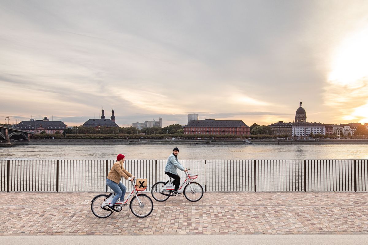 Couple cycling in front of a river