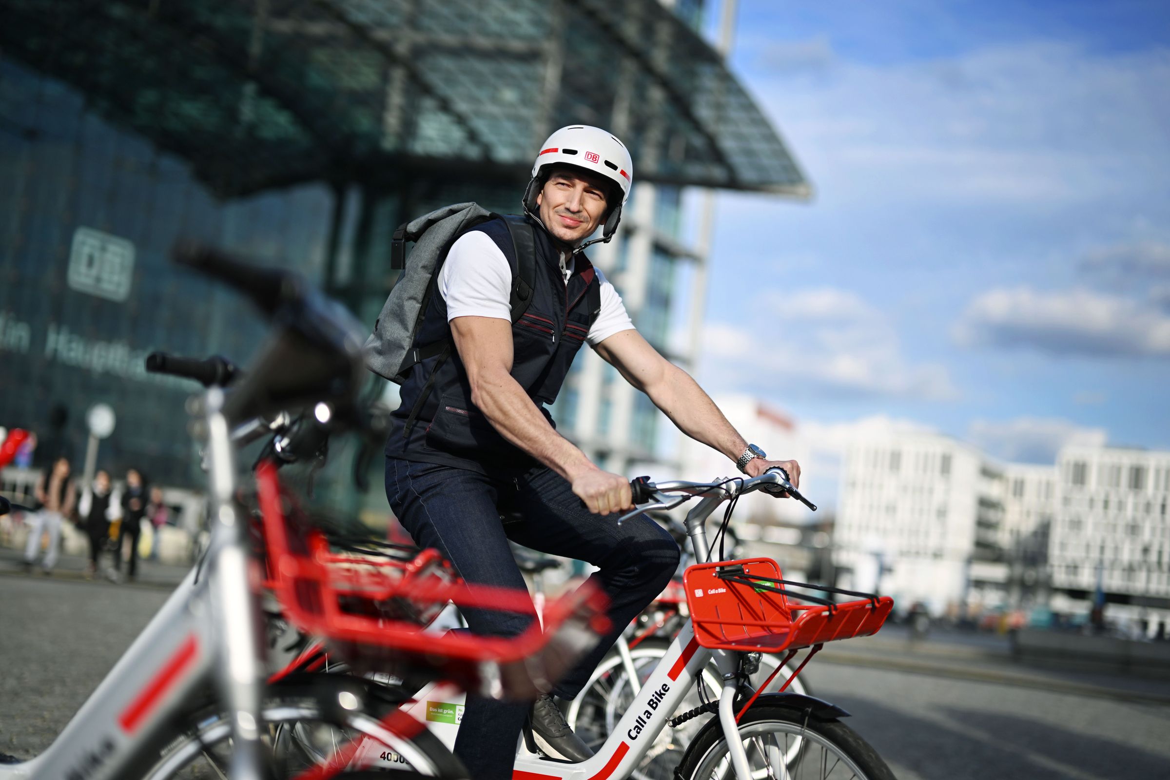 Mann mit Call a Bike vor Bahnhof
