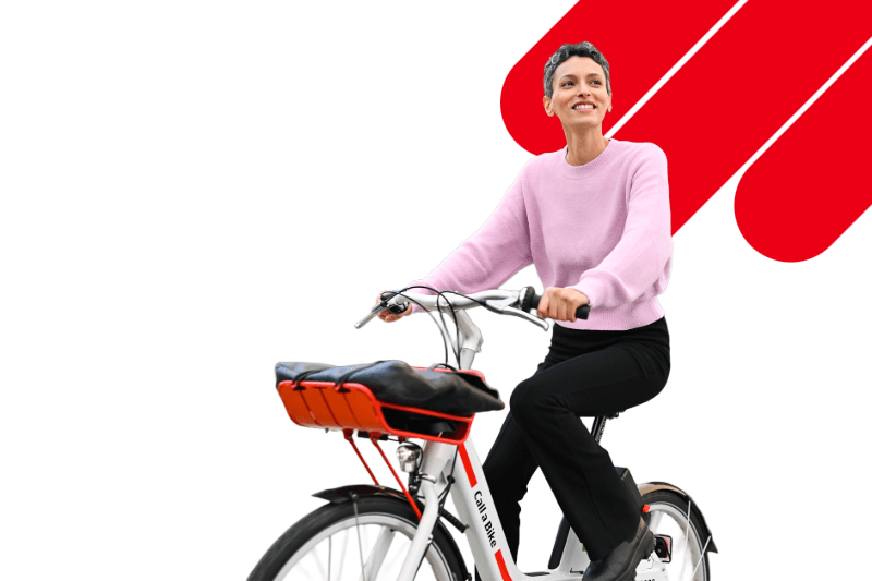 A woman rides a Call a Bike bicycles on red and white background