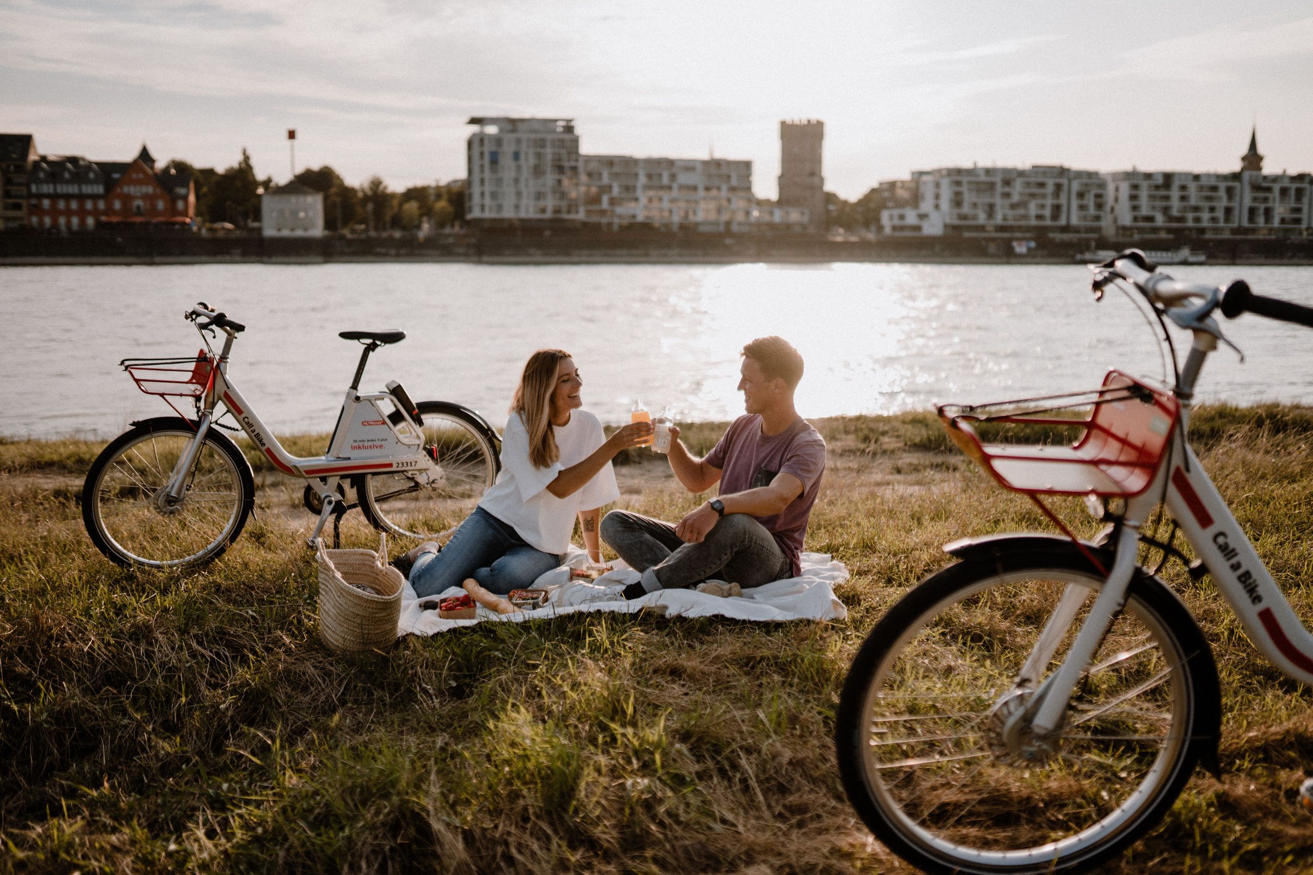 Couple on grass in front of river